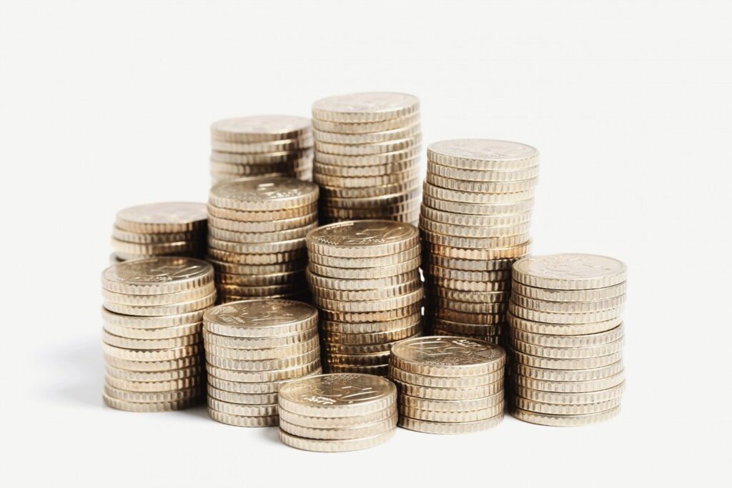 A stack of silver coins from coin specialists set against a white background.